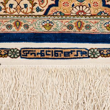 A semi-antique silk Hereke rug, West Anatolia, signed c. 107 x 72 cm.