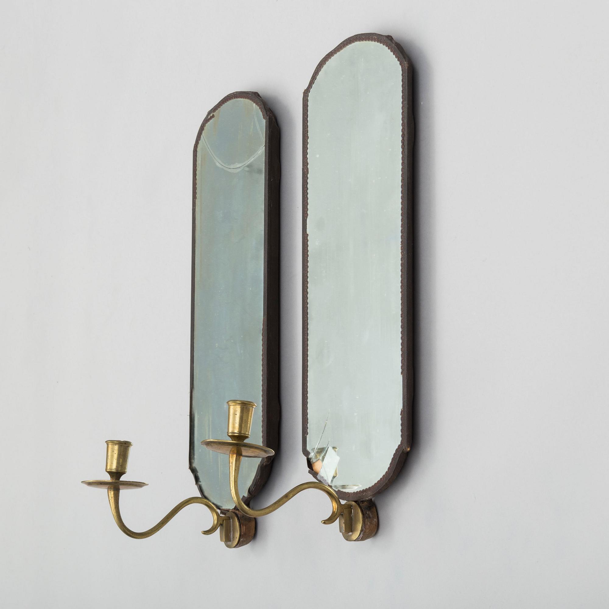 A pair of mirrors with candle sconces, partly 18th century.