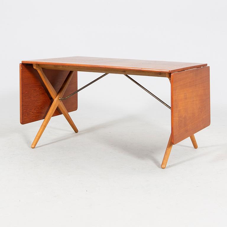 A Hans J Wegner "Savbukkebordet AT-303", teak and oak drop-leaf dining table, Andreas Tuck, Denmark 1950s-1960s.