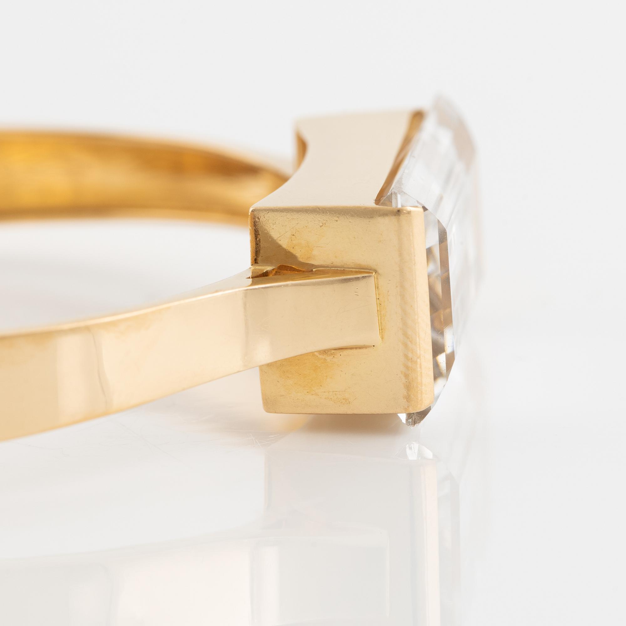 An 18K gold bangle set with synthetic spinel.