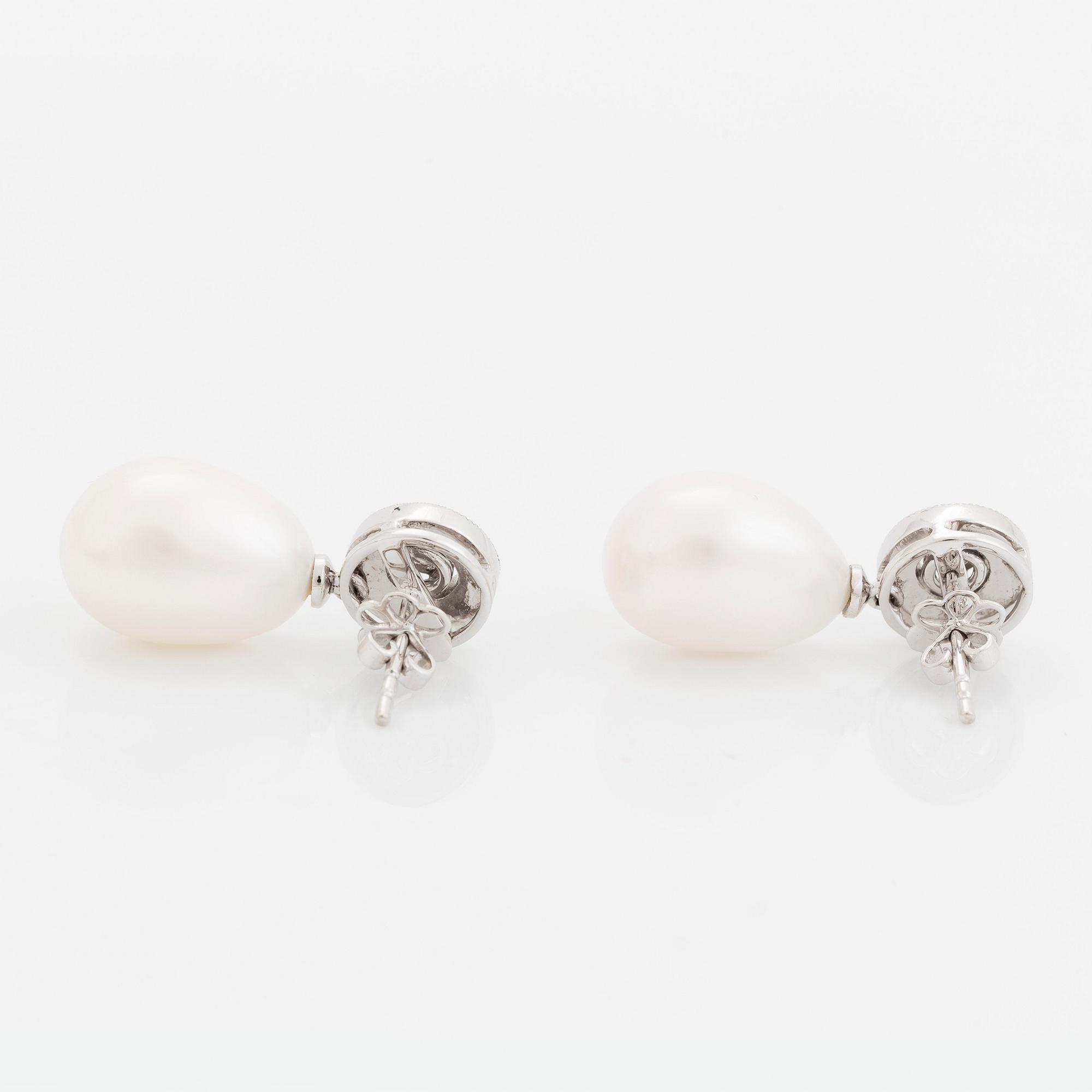 A pair of 18K white gold and cultured pearls earrings set with round brilliant-cut diamonds.