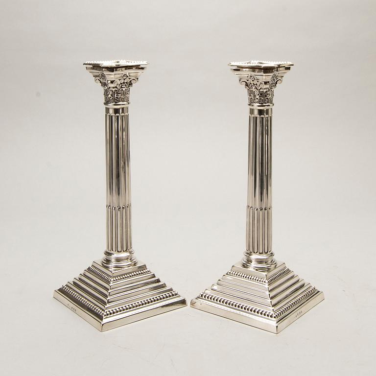 A pair of classical column sterling silver candlesticks Birmingham, 1934, by 'B.G. & Co'.