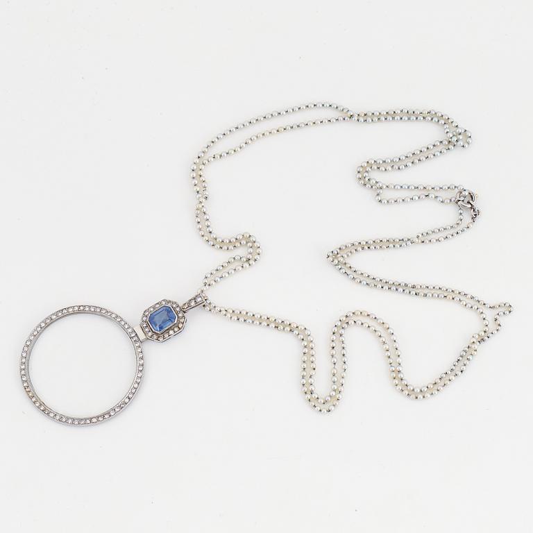 A platinum lorgnette set with a faceted sapphire and rose-cut diamonds.