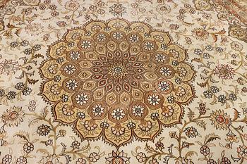 An oriental silk rug, diameter c. 216 cm.