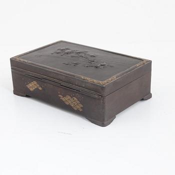 A japanese meji steel box with gold inlays and lid decorated with turtles and frogs. Signed.