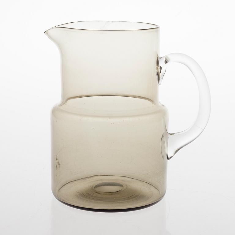 SAARA HOPEA, A glass pitcher and six glasses in rattan basket, for Nuutajärvi. Designed year 1952.