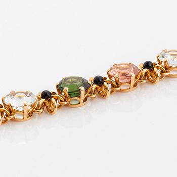 A WA Bolin bracelet in 18K gold set with coloured gemstones.