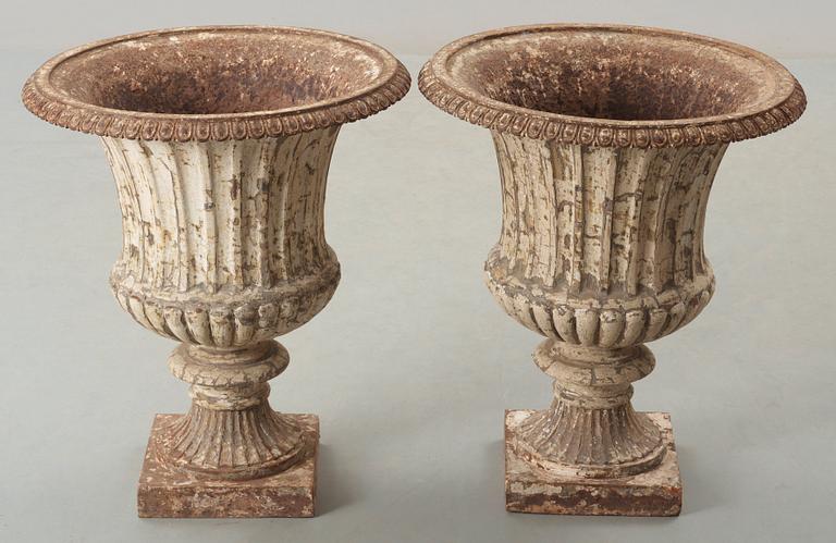 A pair of English 1860's iron garden urns.