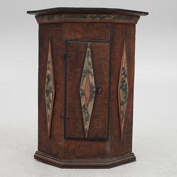 A corner cabinet, 18th Century.