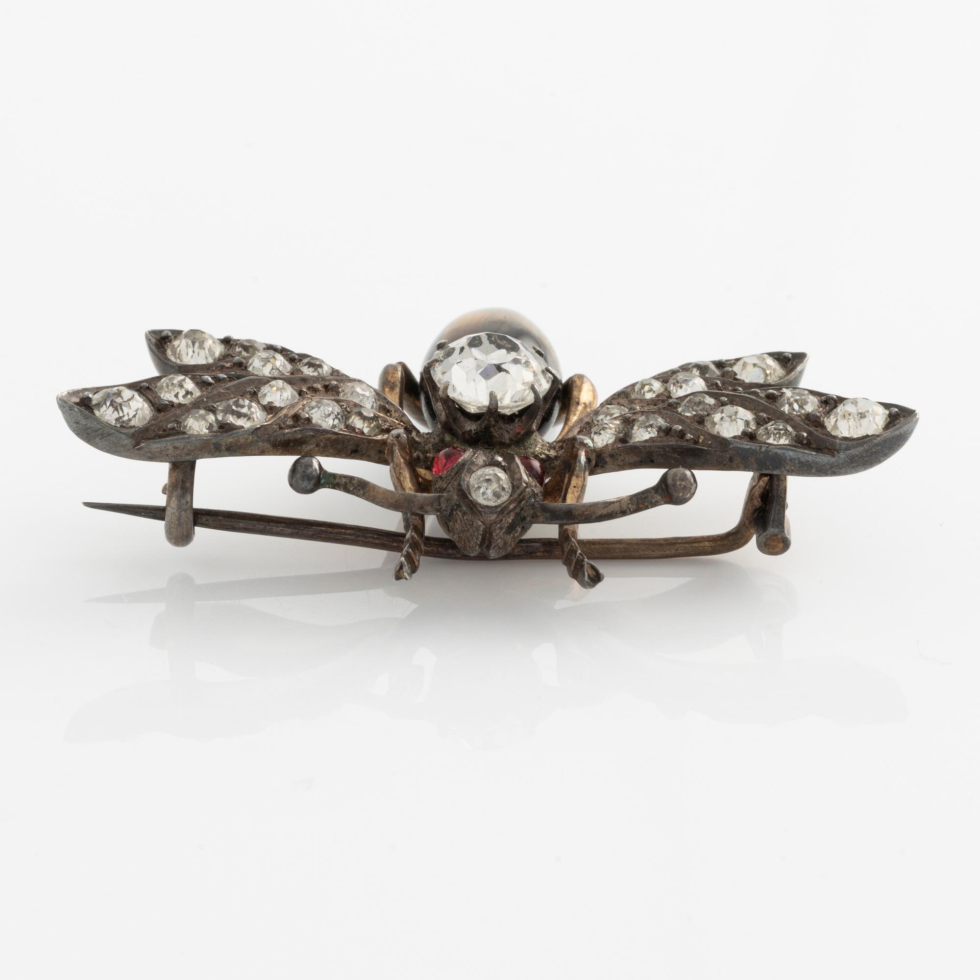 Brooch with white paste stones and tiger's eye.