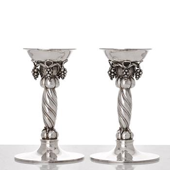 Georg Jensen, a pair of sterling silver grape decorated candlesticks, Copenhagen 1996, design nr 263B.