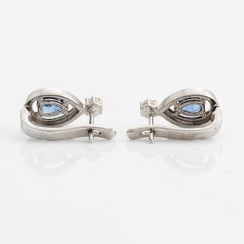 A pair of 14K gold earrings with faceted sapphires and round brilliant-cut diamonds.