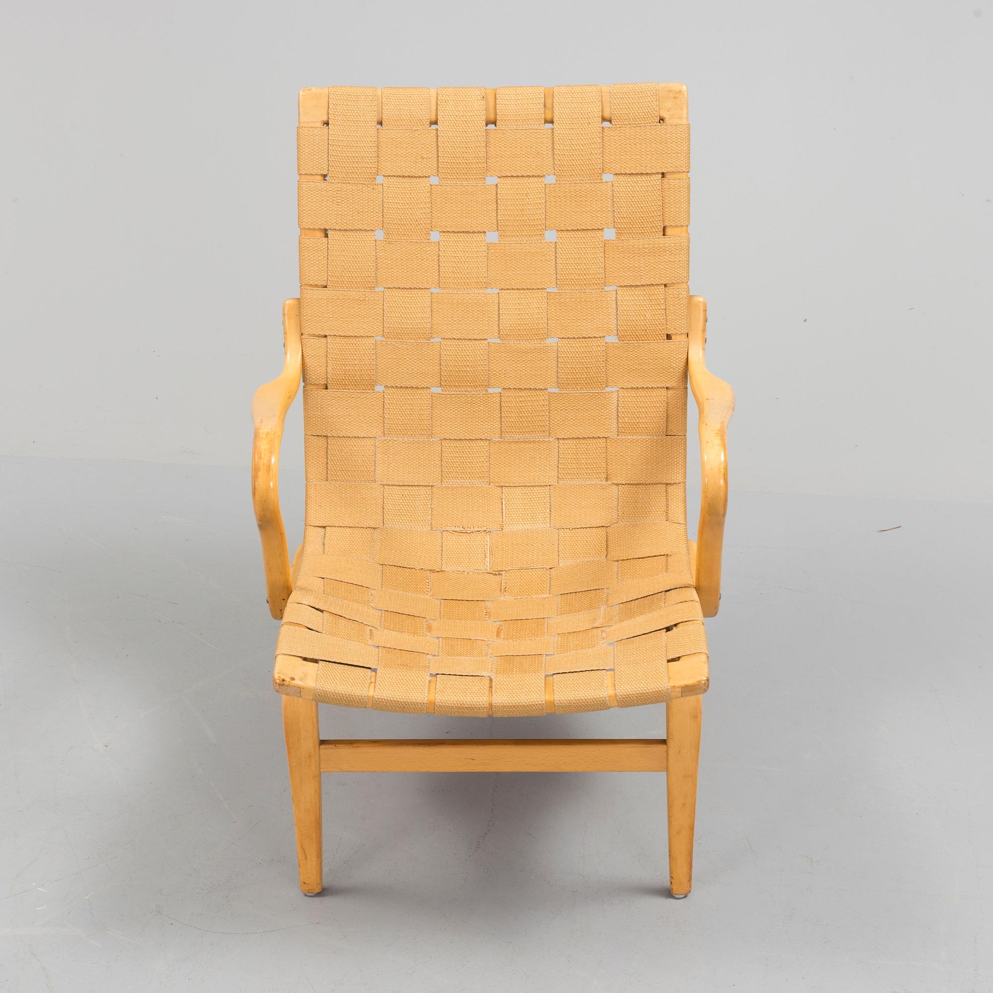 an "Eva" armchair by BRUNO MATHSSON 1963.