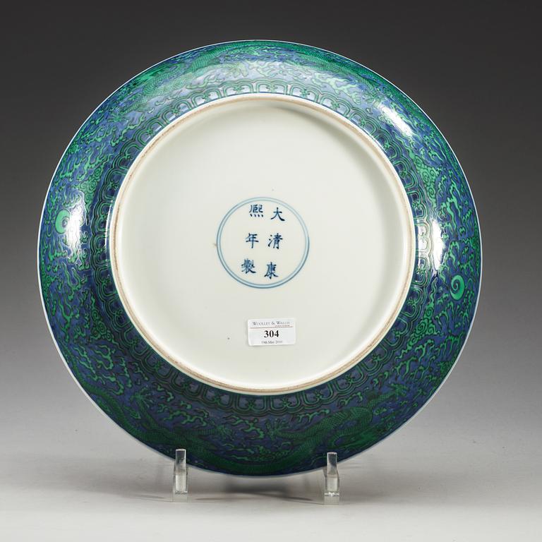 A large green enamelled blue and white dragon dish, Qing dynasty with Kangxi's six character mark.