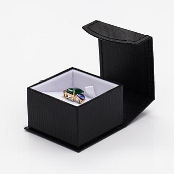 A 14K gold ring with tanzanites and a ca 5.80 ct emerald.
