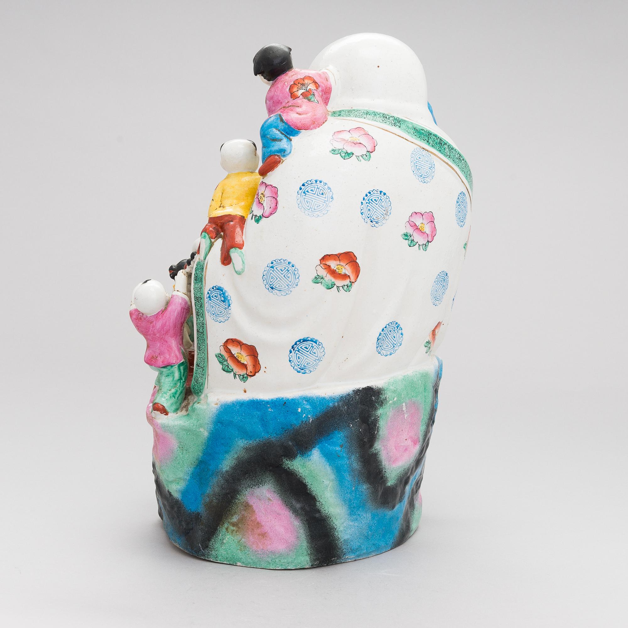 A Chinese porcelain laughing buddha with children, the 20th century.