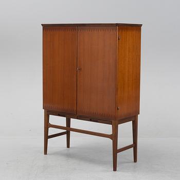 A beech and mahogany mid 20th century cabinet.