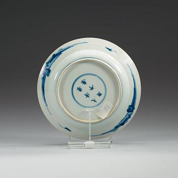 A set of four odd blue and white dinner plates, Qing dynasty, Kangxi (1662-1722), with different six character marks.