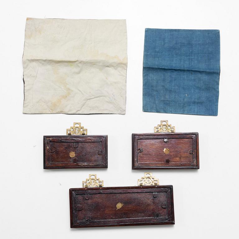 Three Chinese lacquer and wooden panels, two silk embroideries, first half of the 20th century.