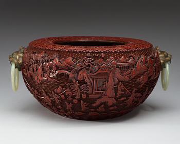 A large red lacquer censer/basin with bronze beast and nephrite ring handles, Qing dynasty, with Qianlong seal-mark.