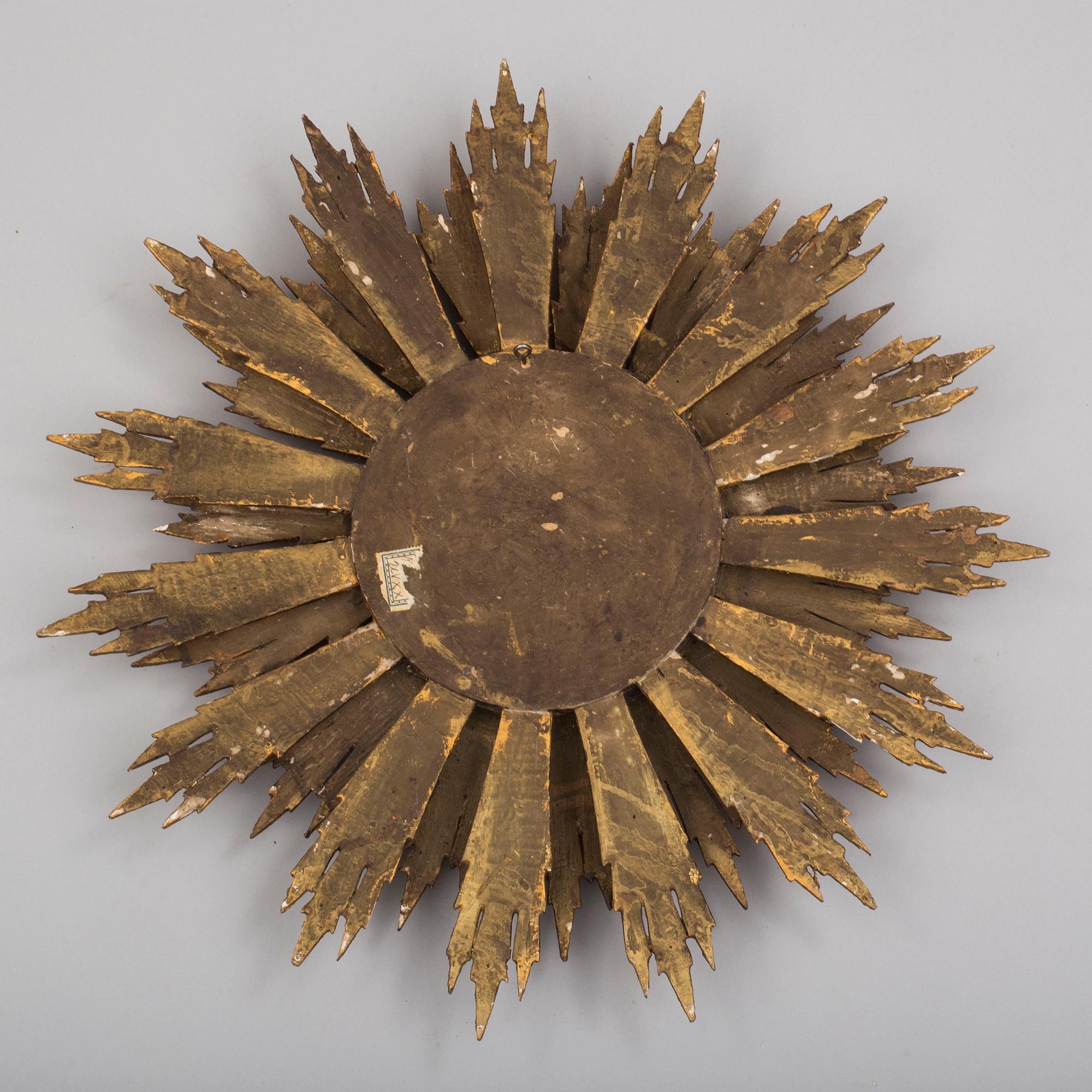 A first half of the 20th century sun mirror.