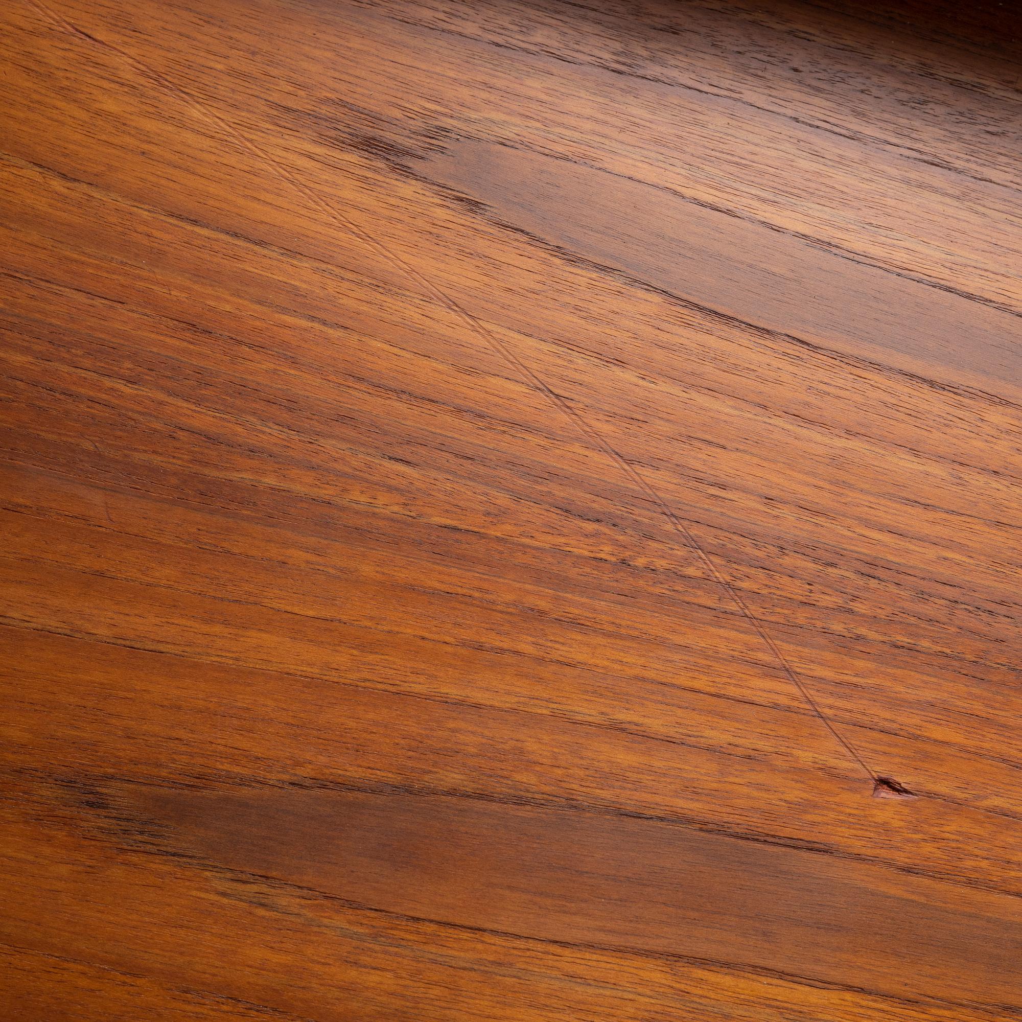 A teak-veneered mid 20th century sideboard.