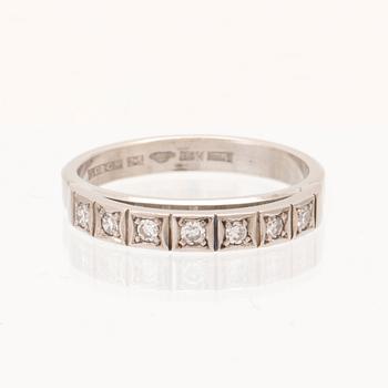 An 18K white gold ring set with round single cut dimamonds.