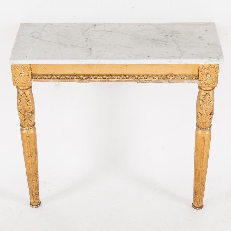 A Swedish Gustavian style mirror and console table with marble top from the first half of the 20th century.