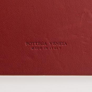 Bottega Veneta, a red leather 'Veneta' Bag.