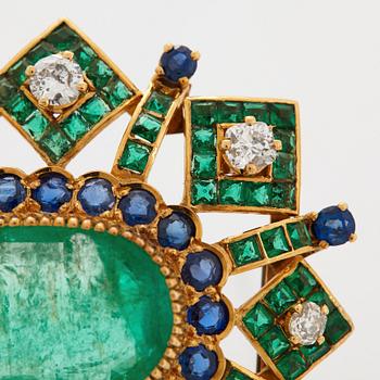 An 18K gold brooch set with an oval emerald and old cut diamonds.