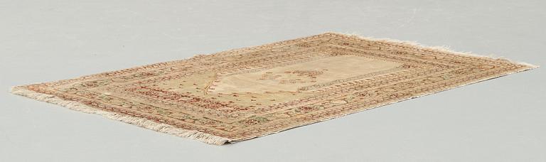 A RUG, an antique silk Tabriz, ca 165 x 118,5-111,5 cm.