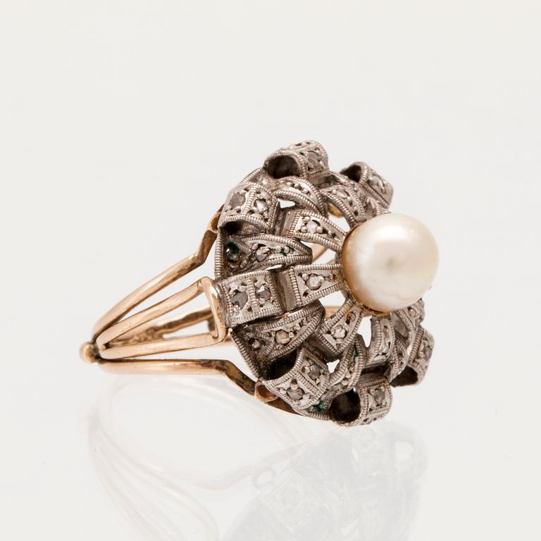 A ring set with a cultured pearl and rose-cut diamonds.