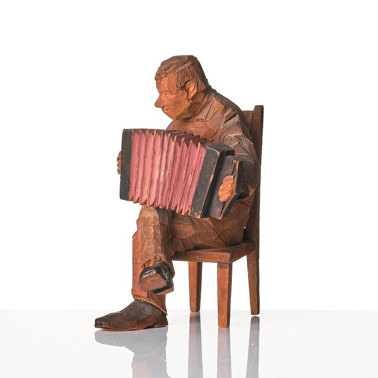 Axel Petersson Döderhultarn, Seated accordionist.