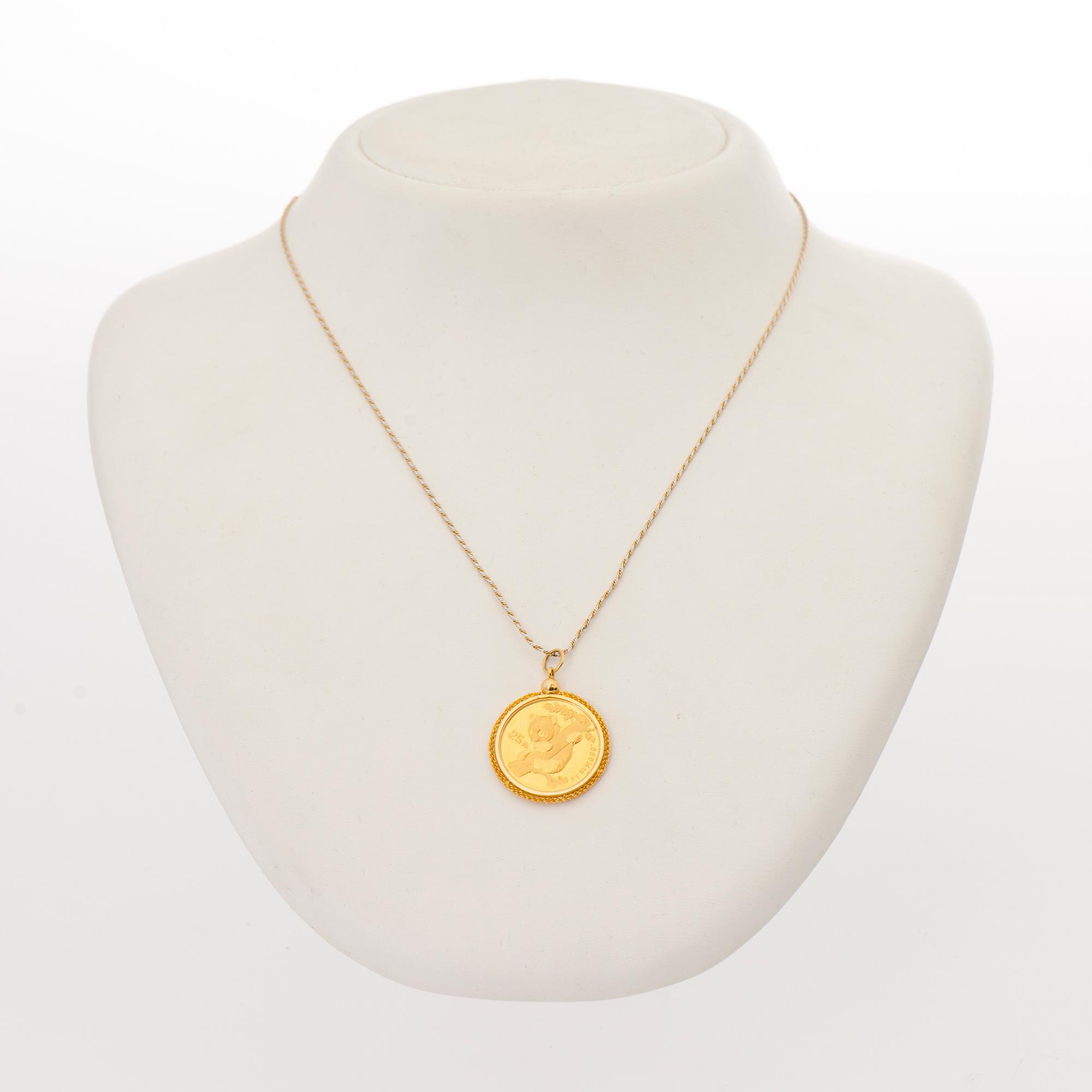 A PENDANT, gold coin 25 yen Japan 1996, setting 14K gold, chain 18K gold. -  Bukowskis