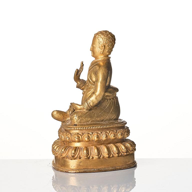 A gilt copper alloy figure of a Lama, most likely Sonam Tsemo., Tibet, probably 16th/17th Century.