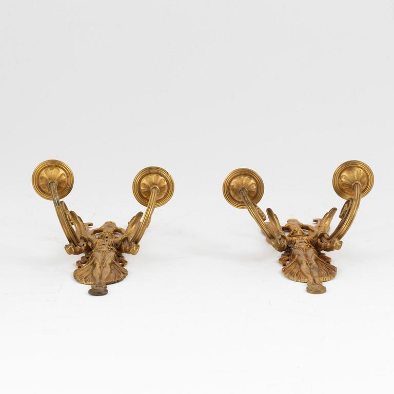 A pair of bronze two light wall-lights, early 20th century.