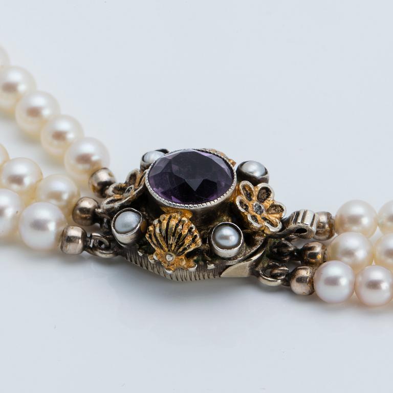 A cultured saltwater pearl collier with silver lock with purple faceted amethyst.