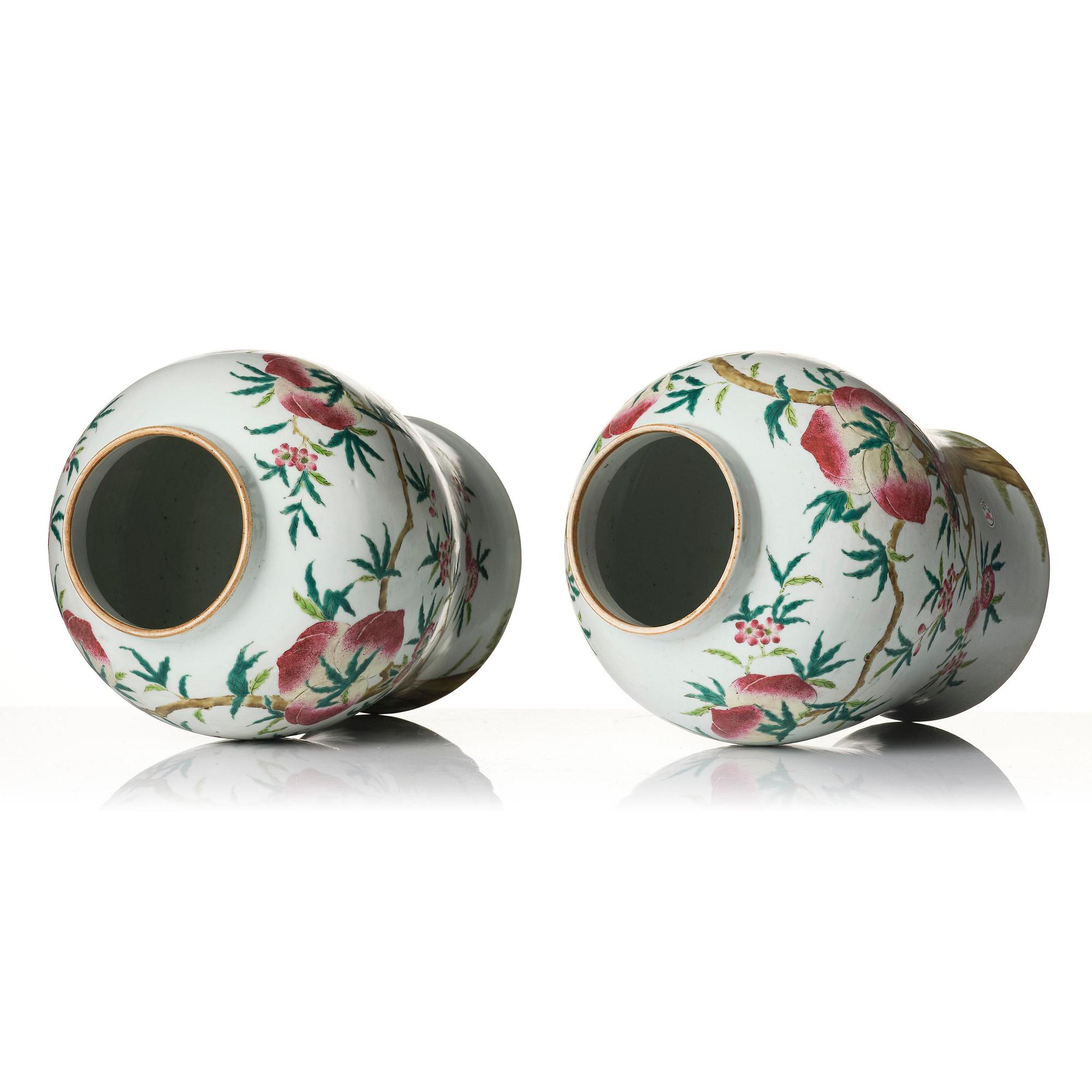 A pair of Chinese famille rose peach vases with covers, late Qing dynasty/circa 1900.