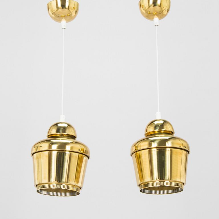 Alvar Aalto, A pair of  A 330, 'Golden Bell' pendant lights A330 for Artek, 2000s.
