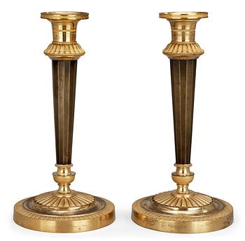 616. A pair of French Empire early 19th century candlesticks.