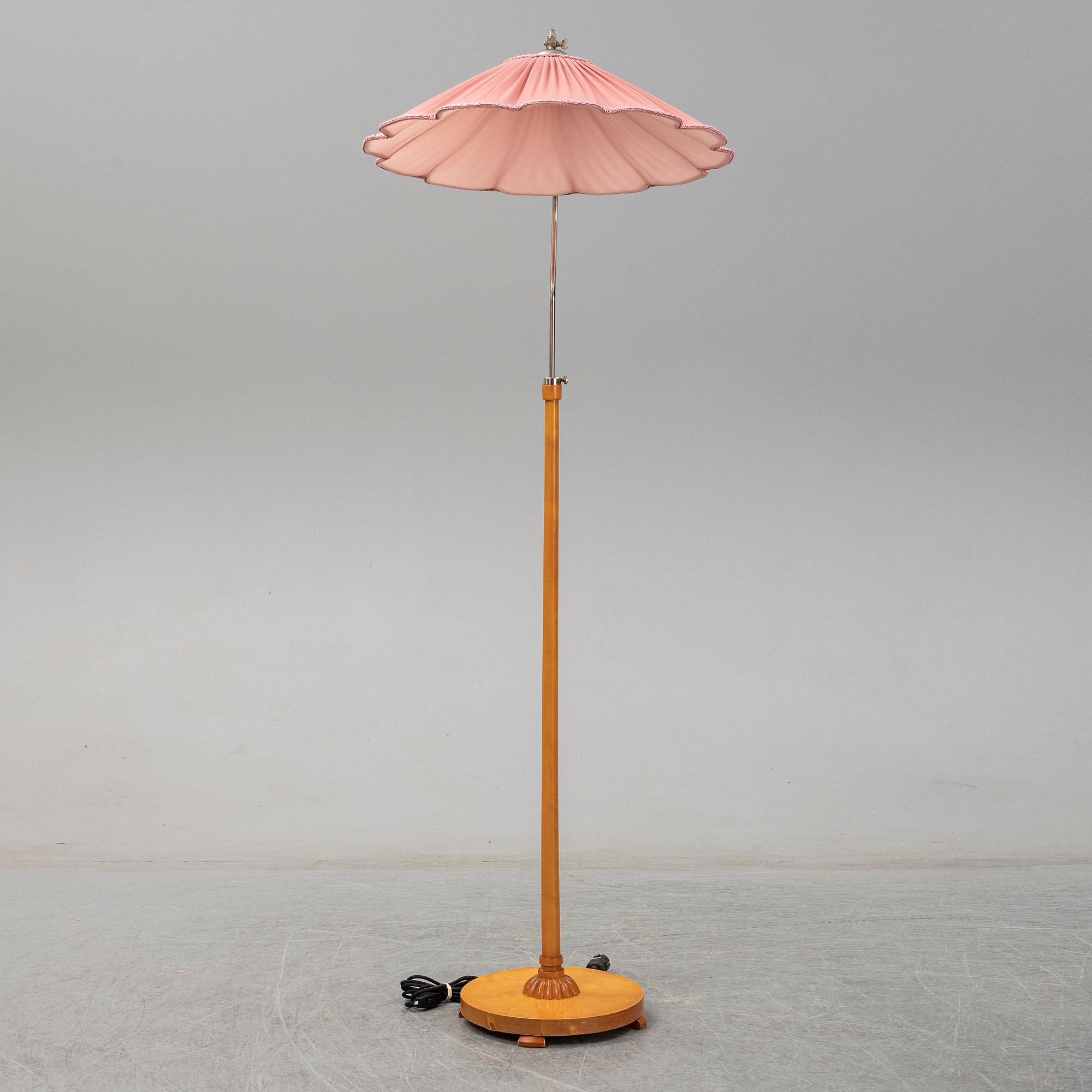 A 1940s birch wood floor lamp.