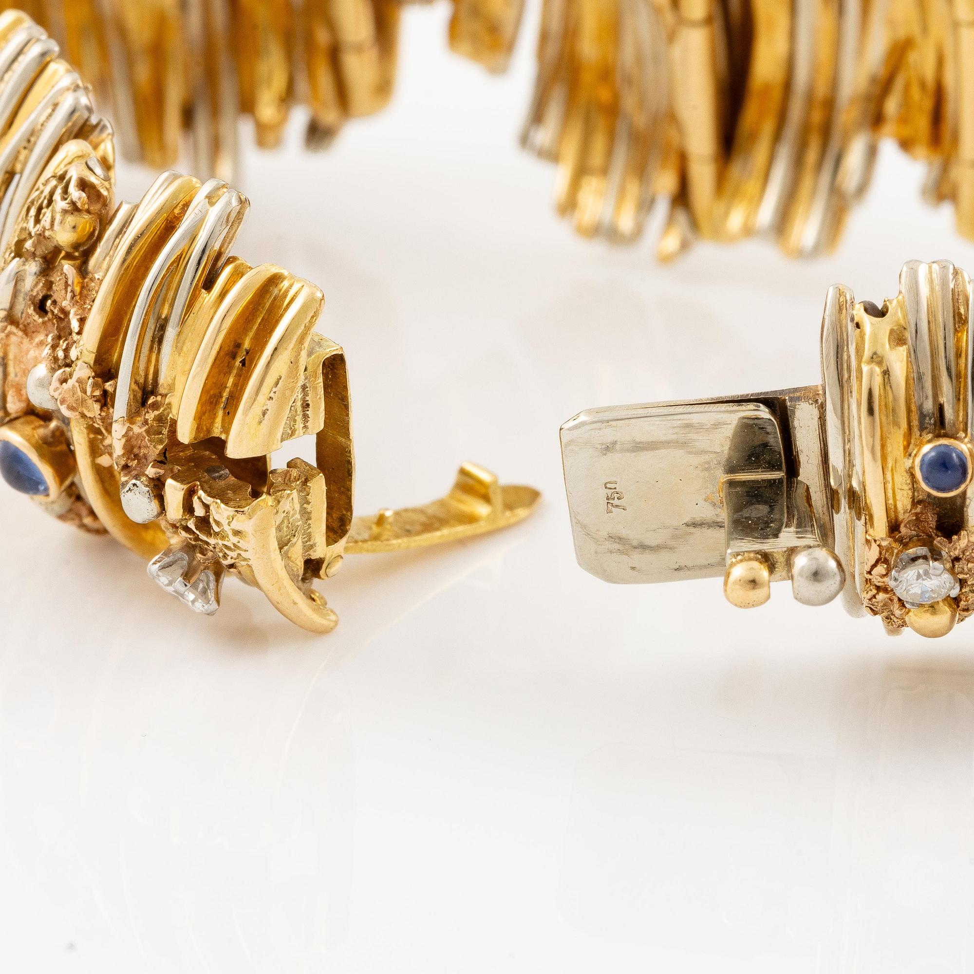 An 18K gold bracelet set with round brilliant-cut diamonds and cabochon-cut sapphires.