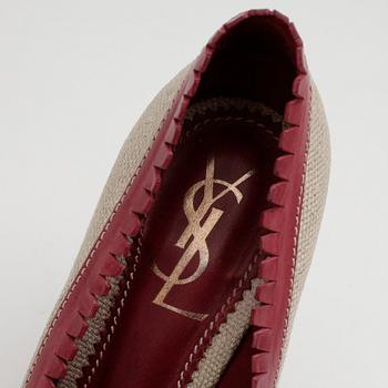 YVES SAINT LAURENT, a pair of red leather and canvas pumps.