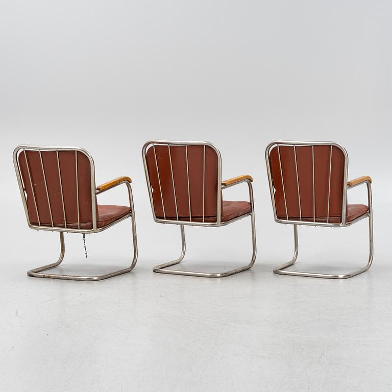 Three tubular steel armchairs, mid 20th Century.