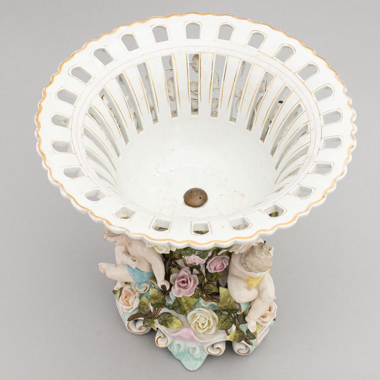A pair of porcelain rococo style candelabra and a centerpiece bowl, Plaue, Germany, first half of the 20th century.