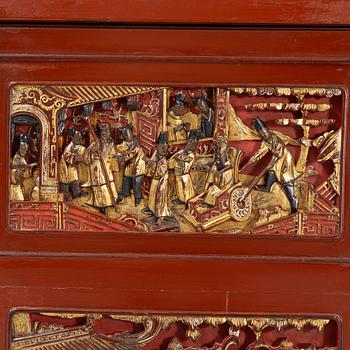 A Chinese cabinet, early 20th Century, with 19th Century carved panels.