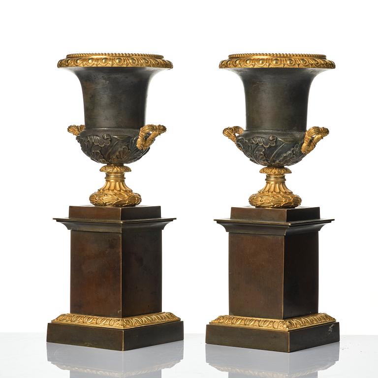 A pair of French Louis Philippe gilt and patinated bronze urns, first part 19th century.
