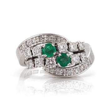 A ring set with round, mixed-cut emeralds and eight-cut and round, brilliant-cut diamonds.