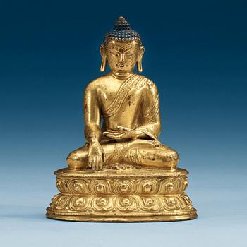 A gilt bronze figure of buddha, Presumably Tibet, 18th Century or older.