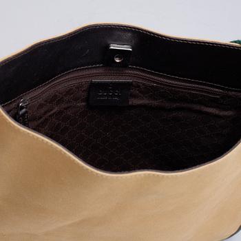 Gucci, a canvas handbag.